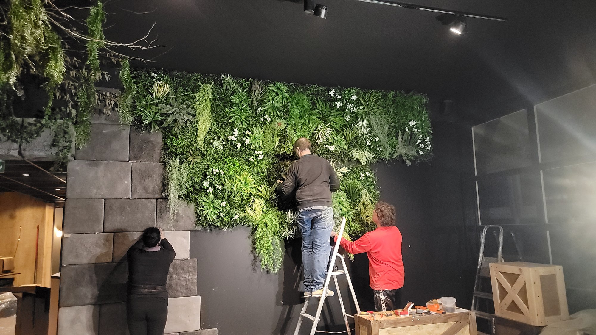 La végétation posée feuille à feuille sur le mur de pierres