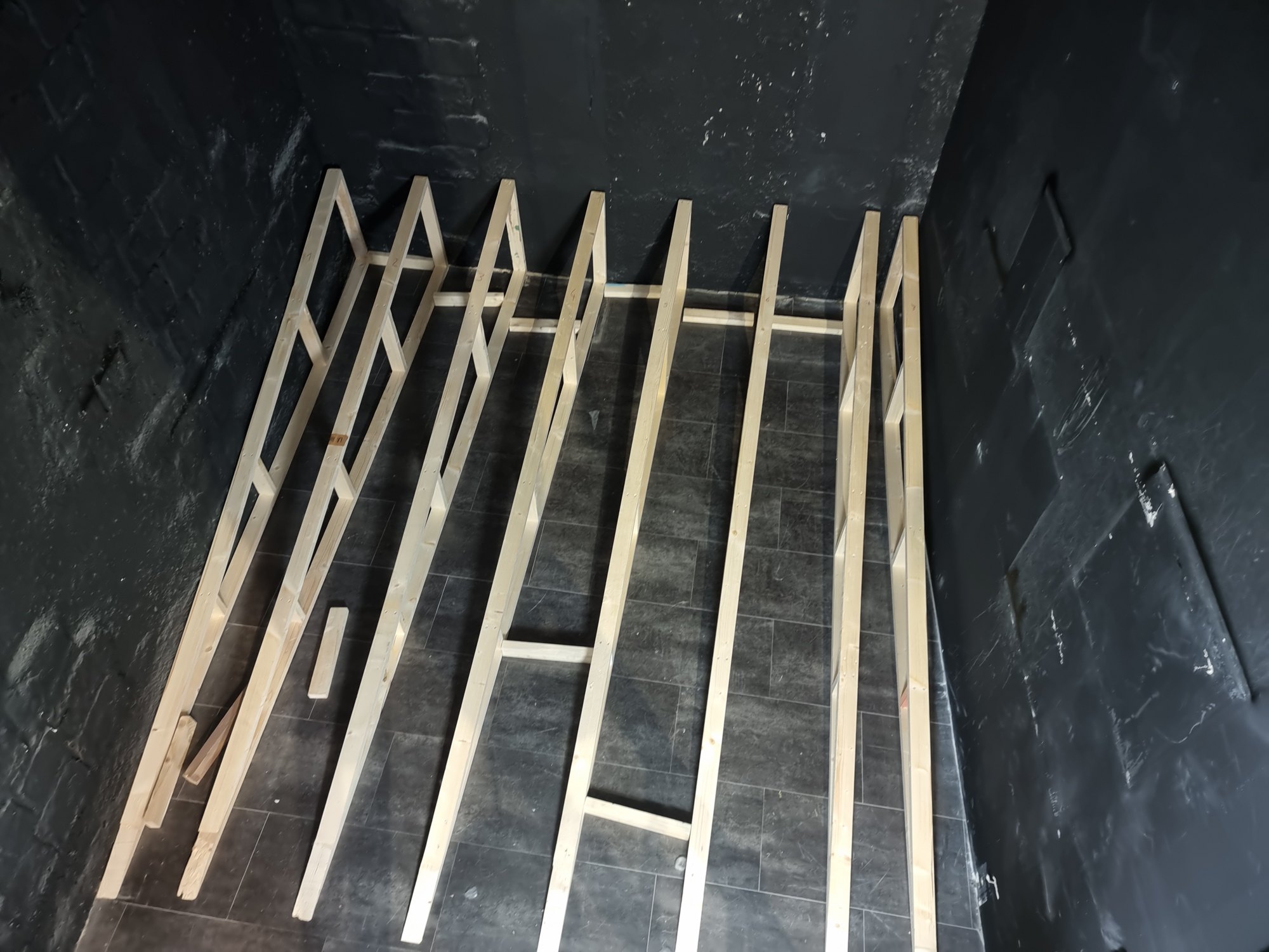 The timber frame of the play barrier, assembled on the floor