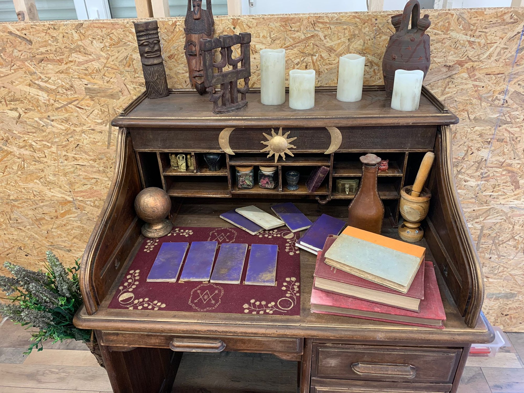 The candlelit writing desk, with its cards and clues