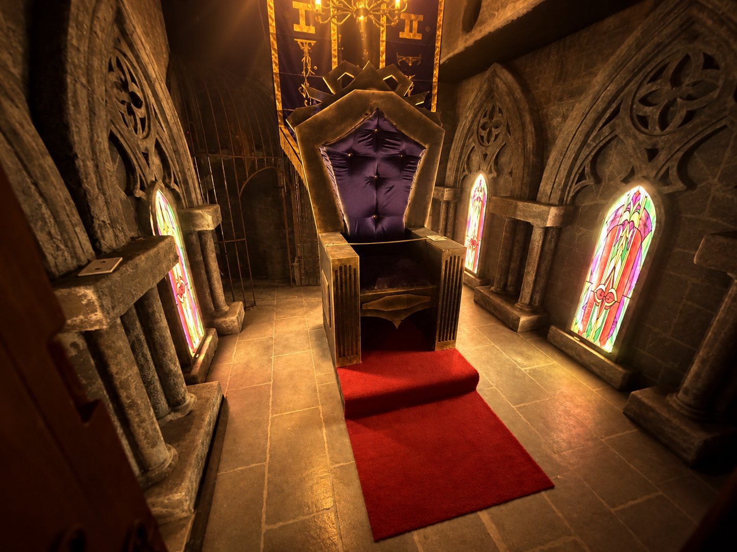The throne under its banner, between the stained-glass windows